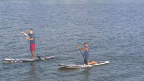 Paddle Boaters paddling by Vídeos de archivo 89510866