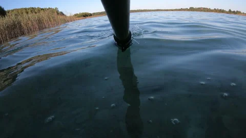 Paddle rowing calm surface of water - horizontal first-person video Stock Footage 280716052