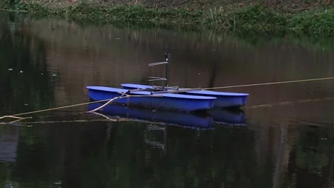 Paddle Wheel Aerator Enhancing Oxygen in Calm River Stock Footage 297511910