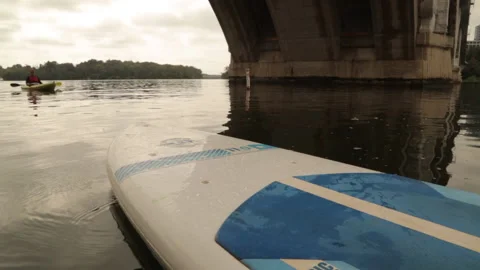 Paddleboard docked under bridge Stock Footage 145737621