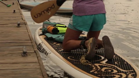 Paddleboard leaving dock Stock Footage 145737618