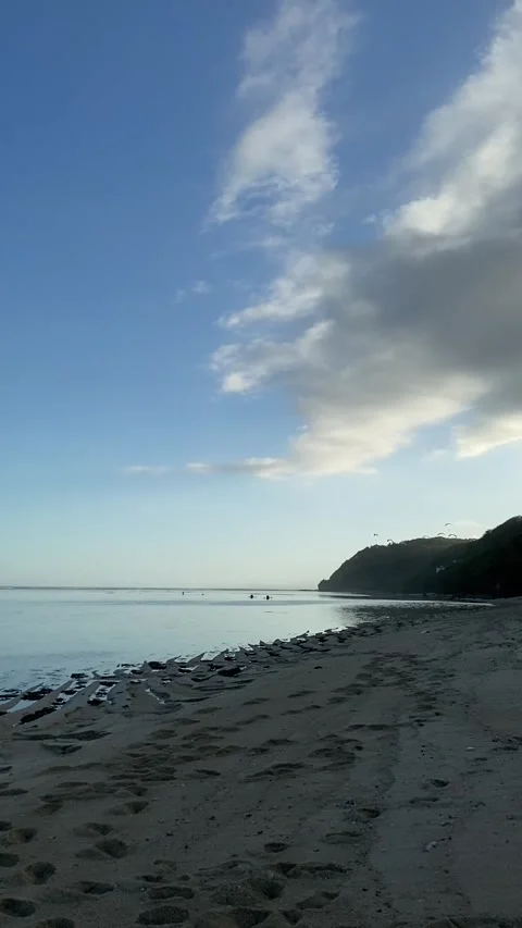 Paddleboarders at Sunset on Tranquil Beach Stock Footage 277318447