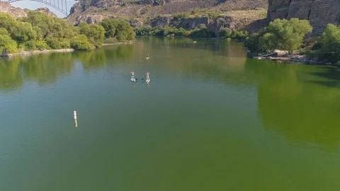 Paddleboarders towards the bridge Stock Footage 126601105