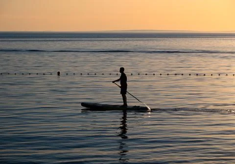 Paddleboarding at Sunset Stock Photos