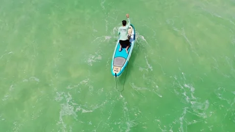 Paddleboarding in waves Stock Footage 242725850