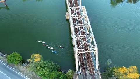 Paddlers Passing Under Train Bridge on Cockle Creek, NSW, Australia Stock Footage 313482771