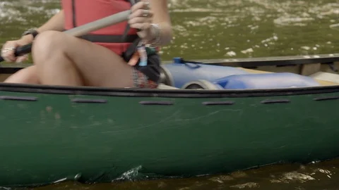 Paddling down a river in a canoe Stock Footage 97702585