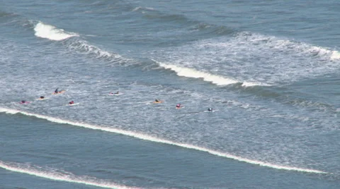 Paddling out through breakers Stock Footage 32129027