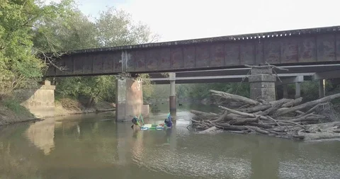 Paddling under a Bridge aboard a Hammocraft Stock Footage 85626047