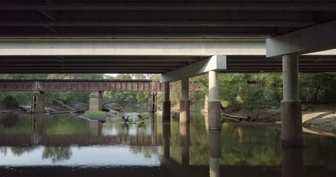 Paddling under a Bridge aboard a Hammocraft II Stock Footage 85626078