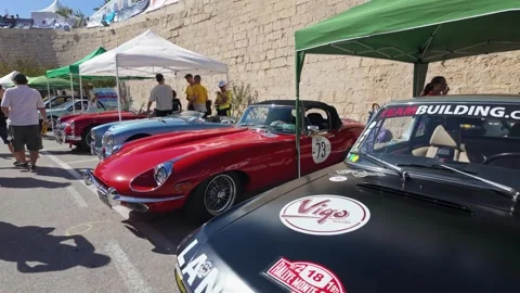 Paddock slow motion lineup Lancia Fulvia Jaguar E-type Austin Healey 100M and Video stock 323050484