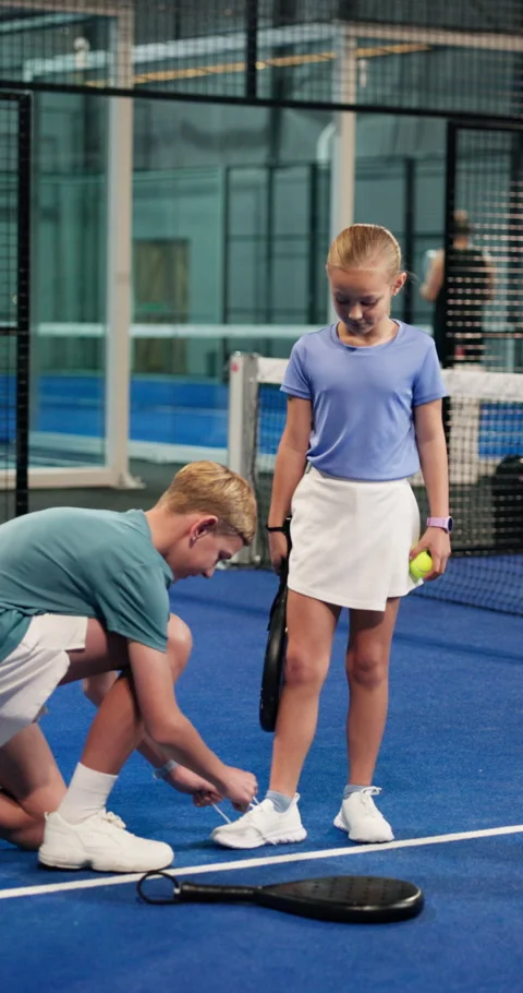 Padel, help and children tie shoes in indoor court for training, exercise and Vídeo Stock 335944277