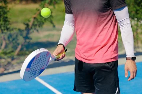 Padel player preparing for serve during outdoor training warmup Stock Photos