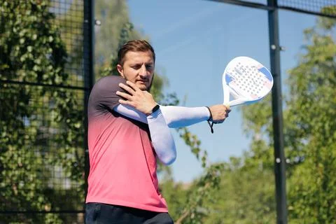 Padel Player Stretching Shoulder Before a Match on Outdoor Court Stock Photos
