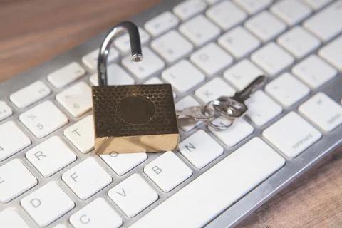 Padlock and key on a computer keyboard. Security and safety concept. 写真素材