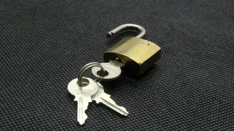 Padlock and key isolated Stock Photos