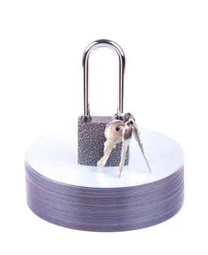 Padlock and key on the stack of cd Stock-Fotos