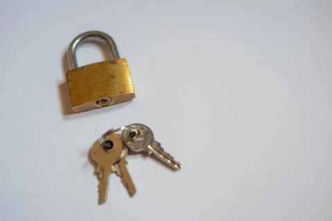 Padlock and key on a white background. Background with copy space small lock and Stock Photos