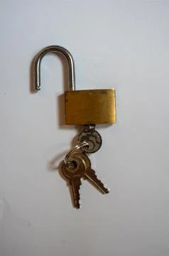 Padlock and key on a white background. Background with copy space small lock and Photos