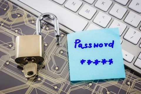 Padlock and password note on circuit board, keyboard. Stock Photos