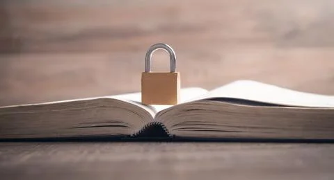Padlock on the book. Information security Stock Photos