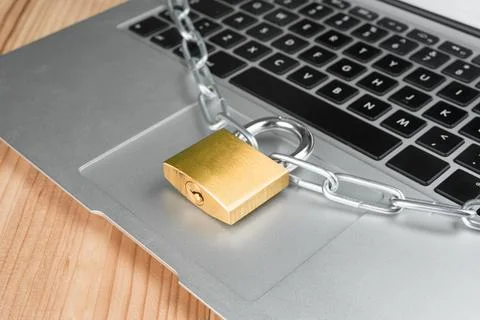 Padlock with chain on a laptop computer. Stock Photos