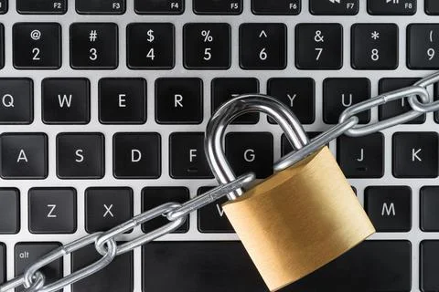 Padlock with chain on a laptop computer. Stock Photos