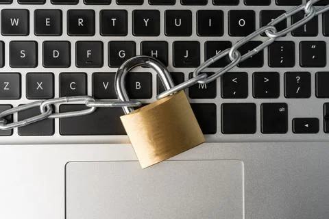 Padlock with chain on a laptop computer. Stock Photos