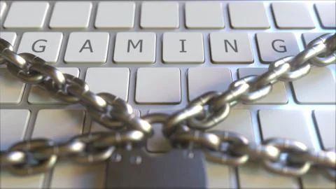 Padlock with chains on the keyboard with GAMING text on keys. Conceptual 3D イラスト素材