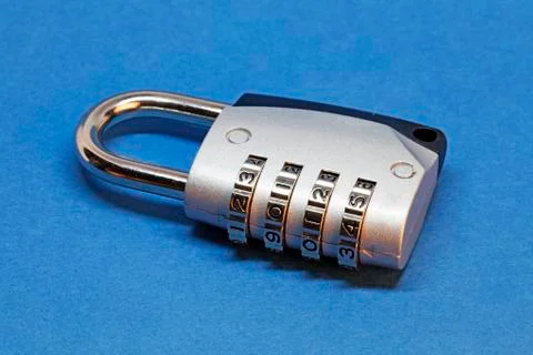 A padlock with combination lock on blue background Stock Photos