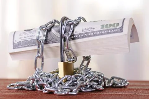 Padlock with dollars Stock Photos
