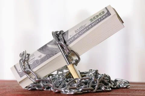 Padlock with dollars Stock Photos