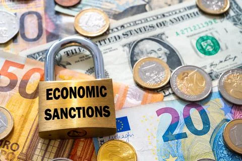 Padlock with "economic sanctions" text next to money. Economic sanctions. Stock Photos