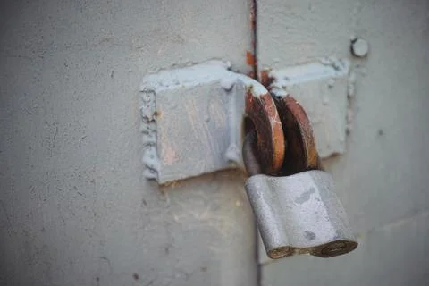 A padlock on a gate. Close-up Stock Photos