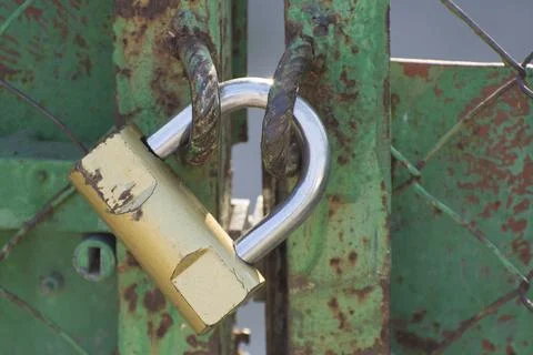 A padlock hangs on the gate. The passage is closed. Stock Photos