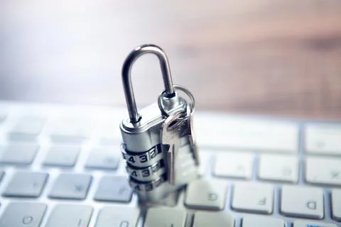 Padlock on keyboard with key. security concept. Stockfoto's