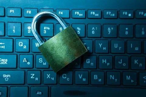 Padlock on a laptop keyboard. Internet security concept. Toned. Stock Photos
