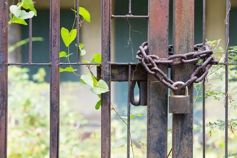 Padlock lasso with rusty chain in the old house. Stock Photos