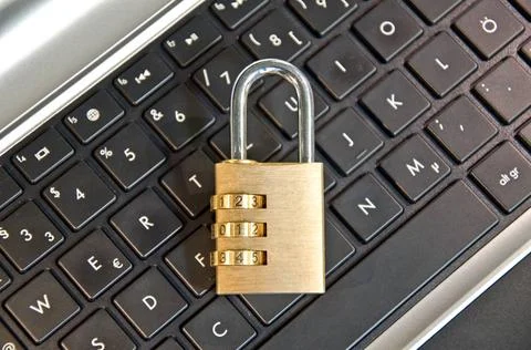 Padlock lying on computer keypad symbolizing data security Padlock lying o... Stock Photos