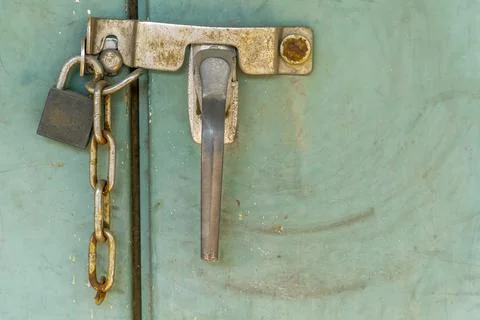 Padlock with rusty chains and green  background vintage style Stock Photos