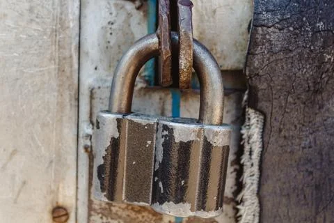 Padlock for secure storage in a closed position. In natural light. Stock Photos
