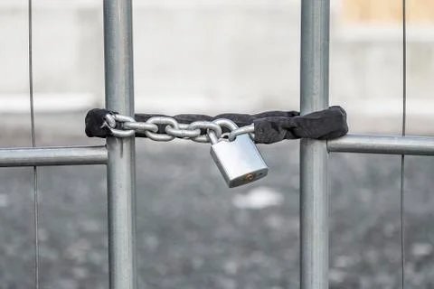 A padlock securing the gate. Stock Photos