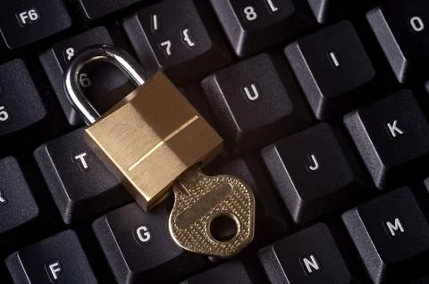 A padlock on top a computer keyboard to represent the concept of computer 스톡 사진