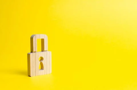 A padlock on a yellow background. information safty. concept of the preserv.. Stock Photos