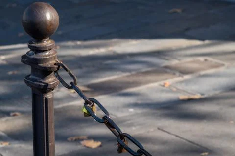 Padlocks attached to a chain in the streets Stock Photos