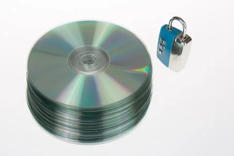 Padlocks behind a stack of compact disc security for your  data Foto stock