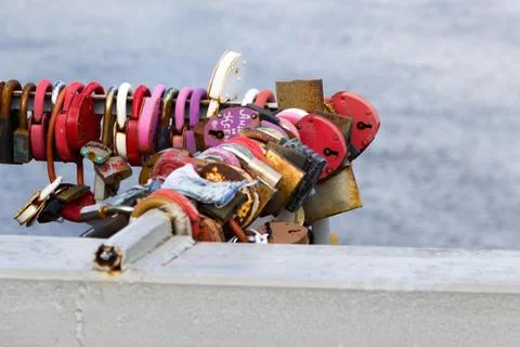 Padlocks hanging on the railing of the bridge Stock Photos