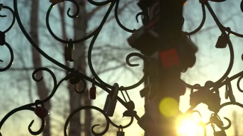 Padlocks on an iron tree on a sunset background. National wedding traditions. Stock Footage 154762561