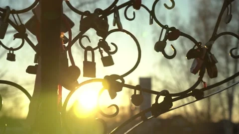 Padlocks on an iron tree on a sunset background. National wedding traditions. Stock Footage 156195312