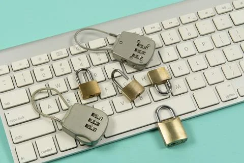 Padlocks over a computer keyboard Foto stock
